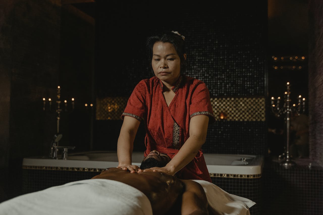 A skilled masseuse provides a relaxing massage in a tranquil spa setting, enhancing relaxation and wellness.